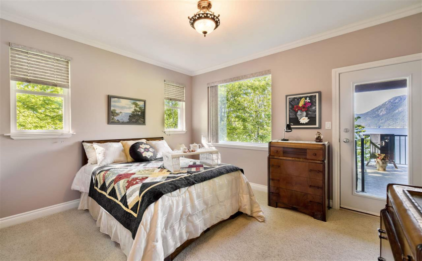 Main floor Bedroom with walk in closet, ensuite and balcony access