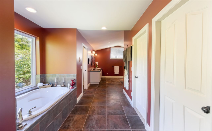 A spacious ensuite with soaker tub and his and her closets.