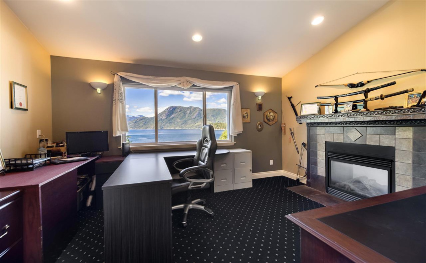 Ocean view den with double-sided fireplace shared with the master bedroom