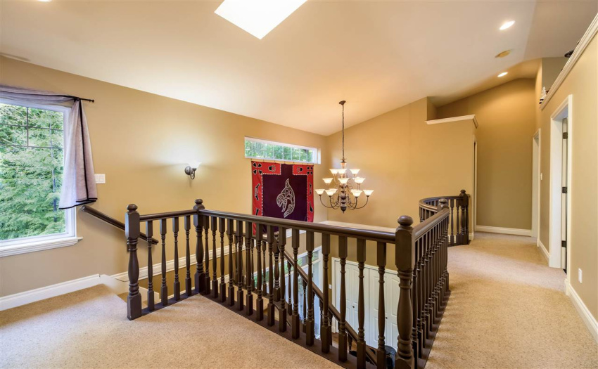 Spacious, upper floor lobby is open to below with skylights above