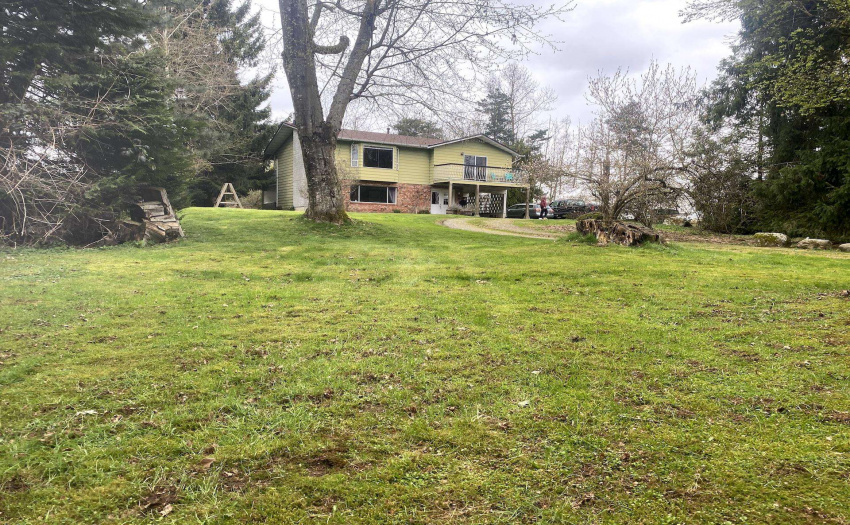 large front yard with wrap around driveway