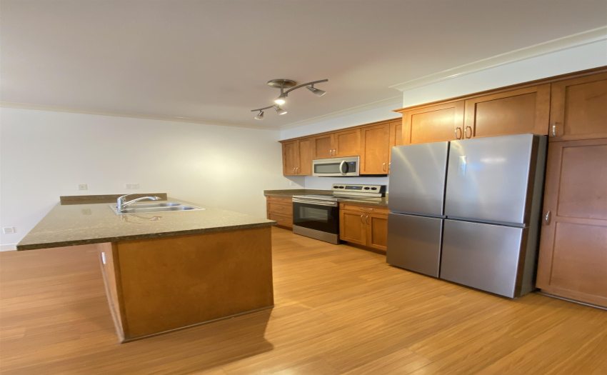 Attractive kitchen with great built-ins, stainless steel appliances and quartz counters.
