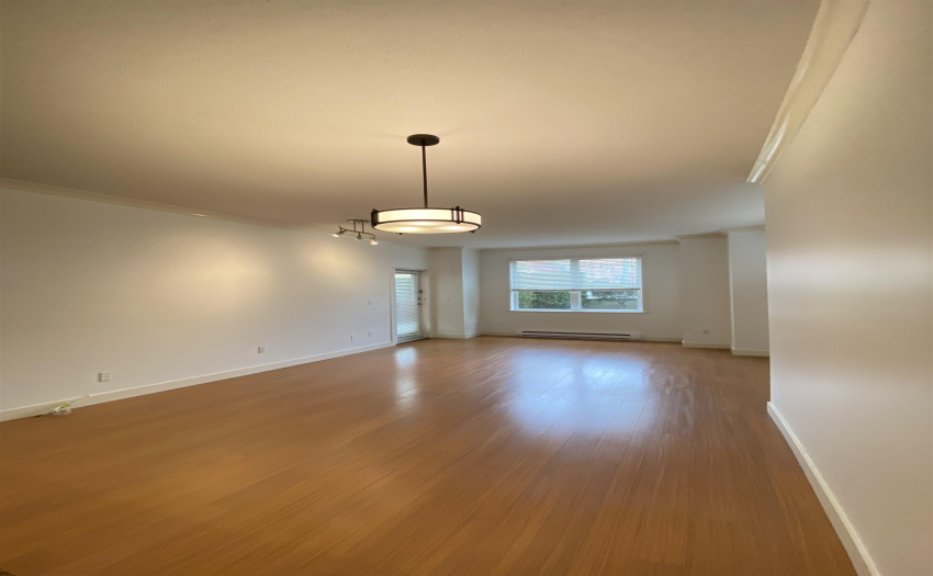 A view of the living/dining area, from the kitchen.  Facing towards front entry.