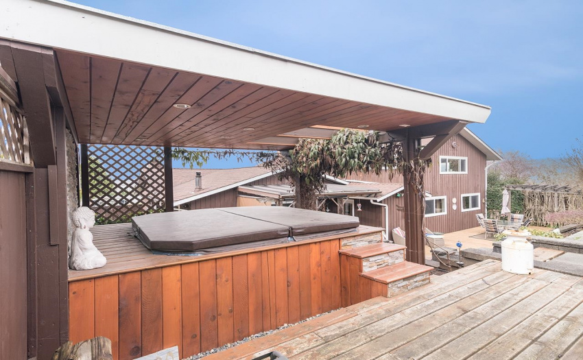 The private covered hot tub is a wonderful spot to relax and enjoy the view