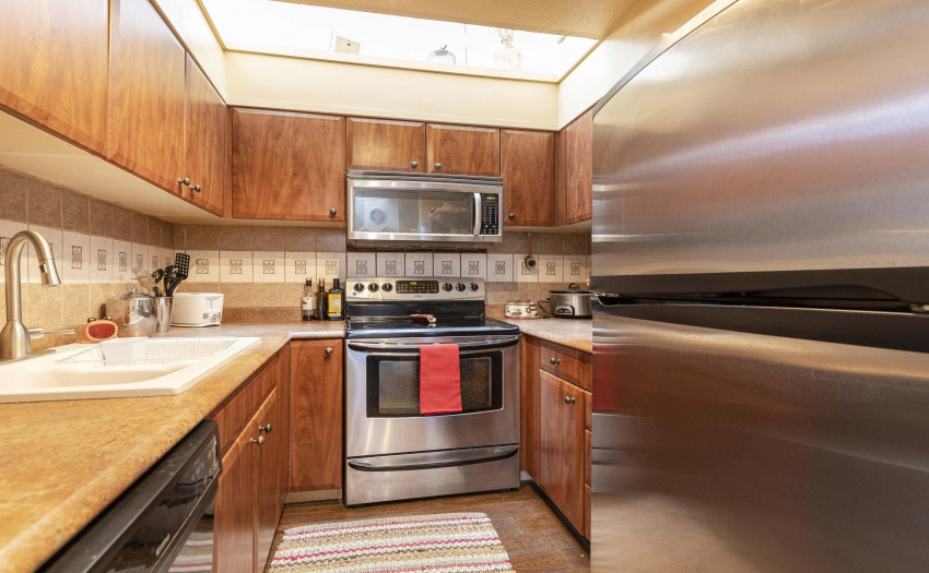 Stainless Steel appliances, tiled floor.