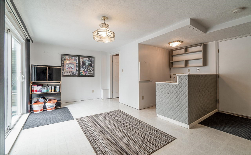 The Laundry room is more than that! Sliding doors to downstairs patio, a 3 piece bathroom handy to the yard, and a BAR!