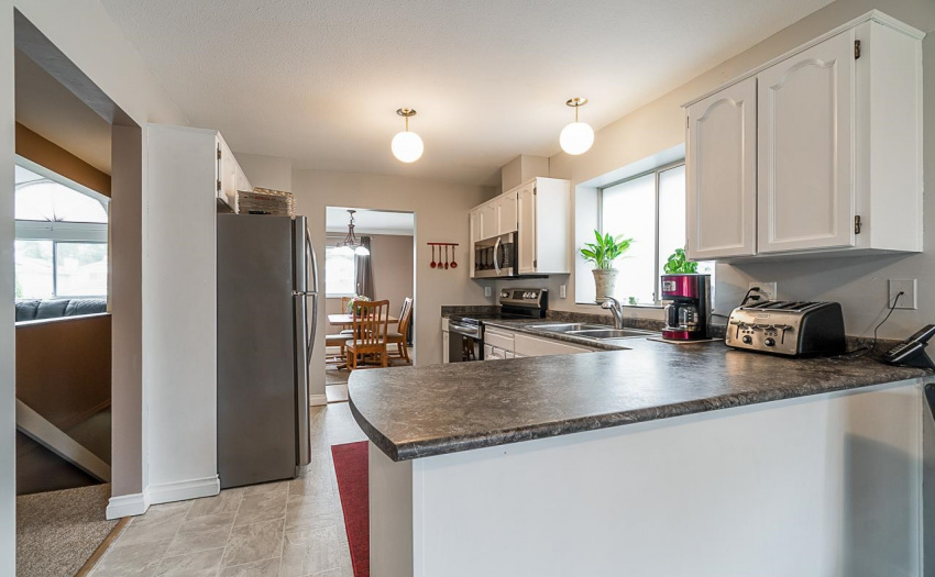 View of kitchen from eating area through to the dining room