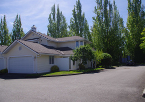 PRIVATE end unit with double garage and two guest parking spaces in front.