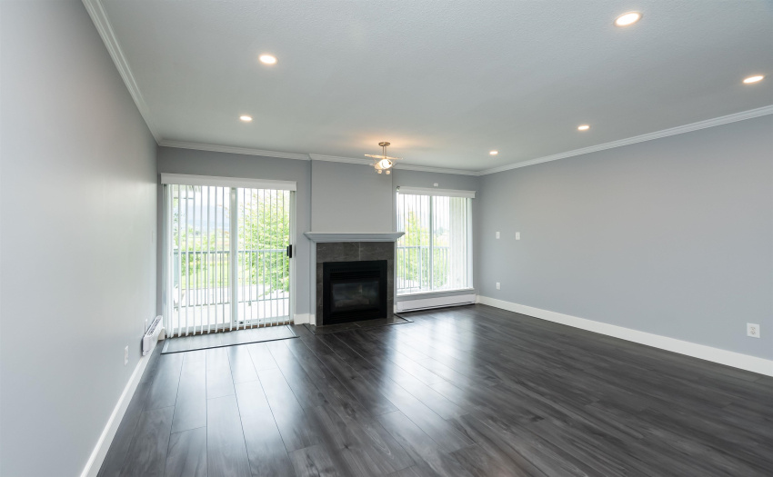 has cozy gas fireplace with Heritage Style mantle and access to large balcony with Mountain view.