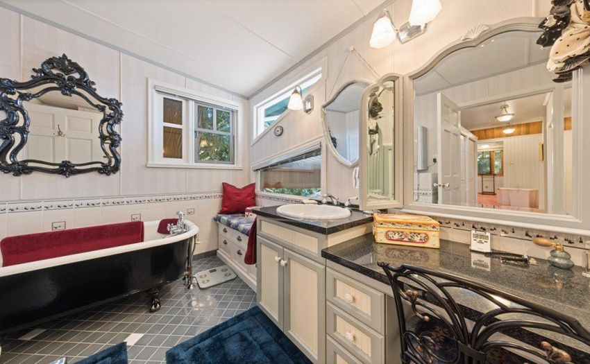 What is more luxurious than your very own bathroom. This one was specially designed by the lady of the house utilizing the original homes claw foot club and includes a sit down make up table.