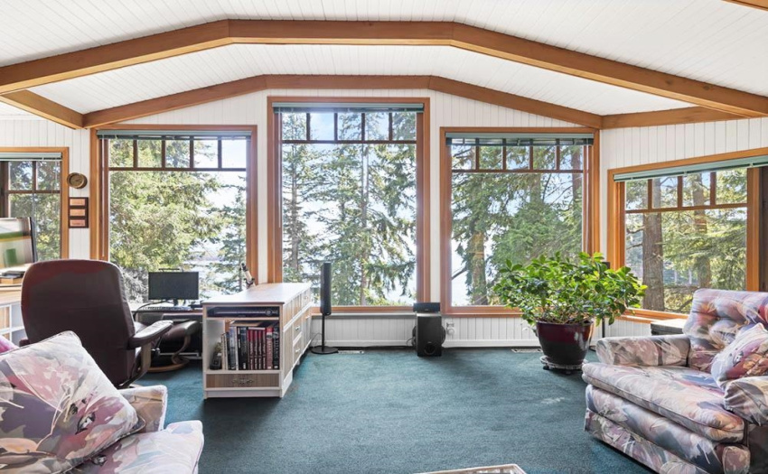 Surrounded by floor to ceiling windows, the living room enjoys filtered views of the ocean and continuous entertainment from the birds frequenting the garden. Notice it???s completely private too!
