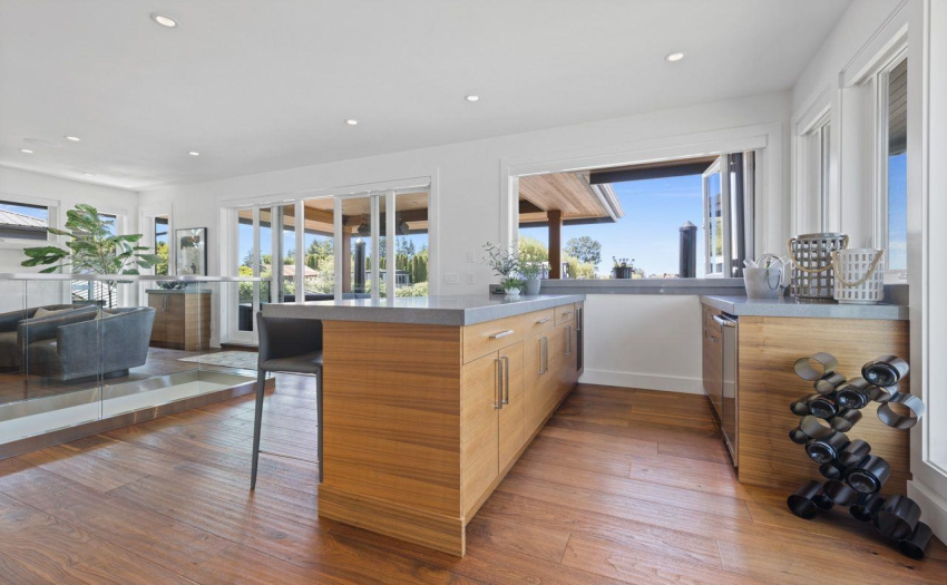 Walnut cabinetry against oiled walnut flooring.  Wet bar with full access to outer deck area.
