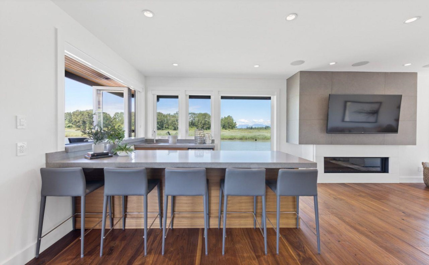 Wet bar with plenty of seating for guests.  Wall mounted TV and Linear Gas fireplace.