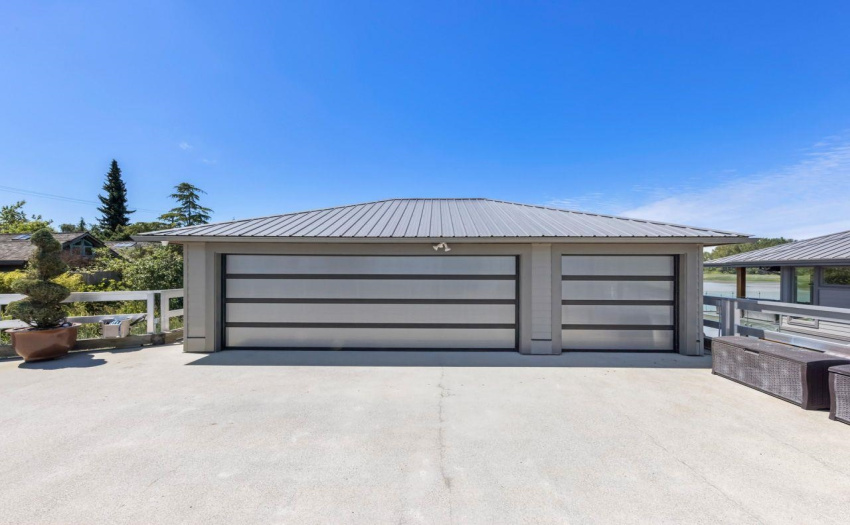 Currently one bay is a workshop.  Gas fireplace for warmth and a huge parking pad plus extra parking on dyke.