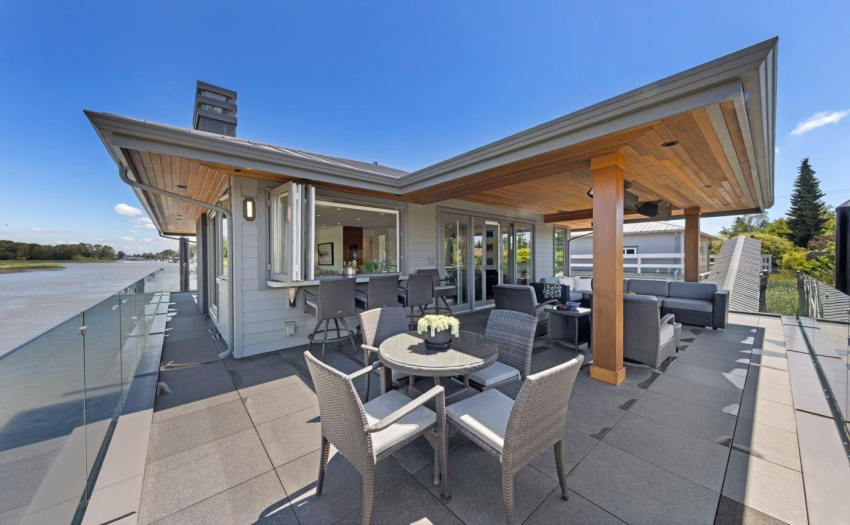 Boats sailing by below while you enjoy your covered dining and conversation area.  Glass windows fold back for seating next to indoor wet bar.  Over head gas heaters keep it comfortable all year round.