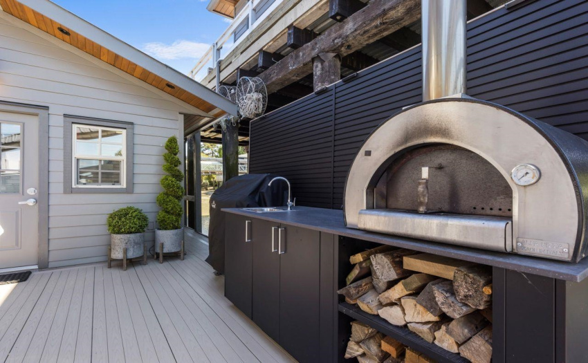 Sink, Pizza Oven and BBQ.  Shed for outdoor storage. PVC Decking.