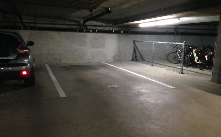 Full size parking stall with lots of room to enter and exit on one side (next to common bike storage area)