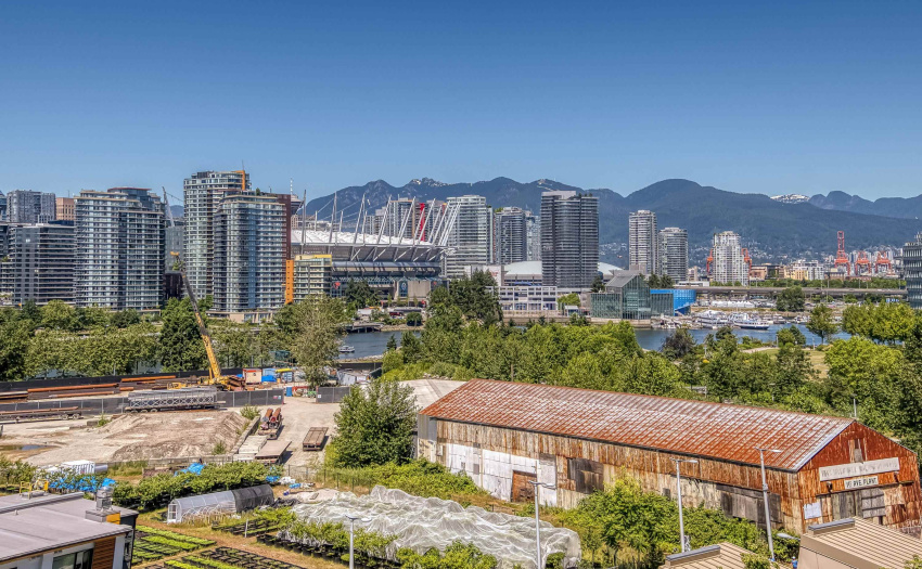 View from the balcony of the city, False Creek and the North Shore mountains beyond.