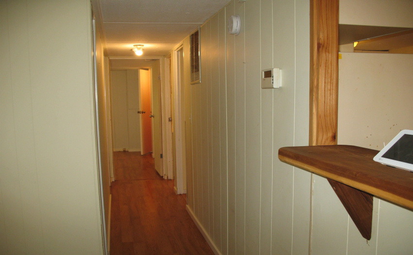 View from end of kitchen counter looking down the hall to the bedrooms.