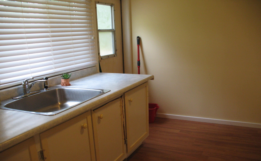 This room is off the laundry/kitchen area - separate sink with a door to an outside deck leading to the back yard; has been used as a mudroom.