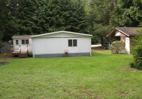 Looking towards the front of the lot.  To the right is the garage with the man door access.  To the right is an addition of approx 100sf with a separate door access.  Lots of sunshine too!