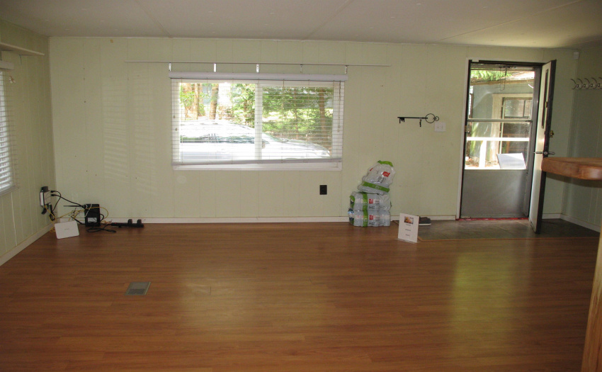 View from kitchen/dining area to the front door - spacious living room has lots of natural light.