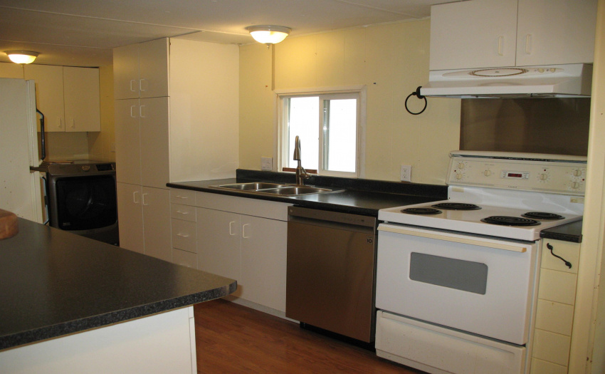 Galley style kitchen with updated dishwasher.