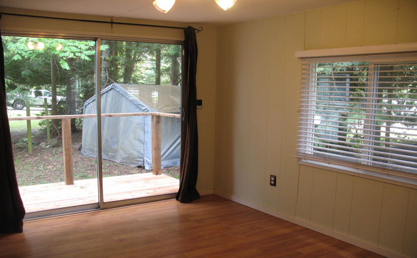 Lots of light in the dining room, with a patio door to the outside.  New deck with stairs to back area.