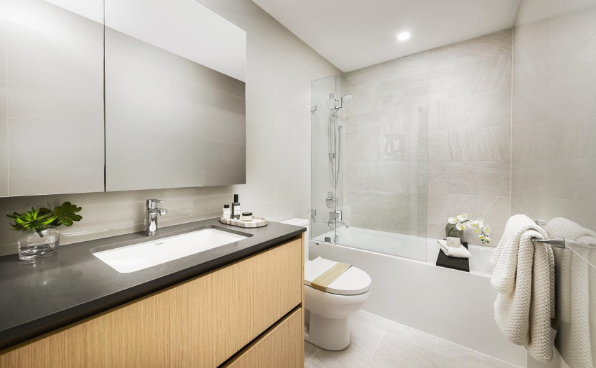 An indulgent soaker tub with glass bath shield