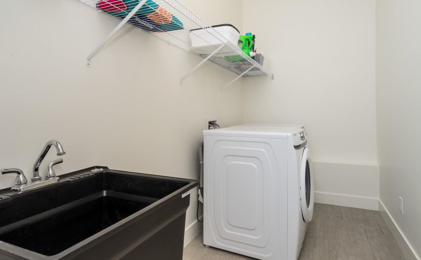 Laundry with wash basin and storage for Upstairs - near garage for easy cleanup.