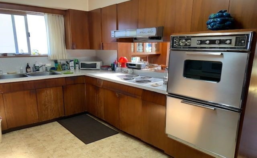 Original cabinets and B/I wall ovens and electric cook top.