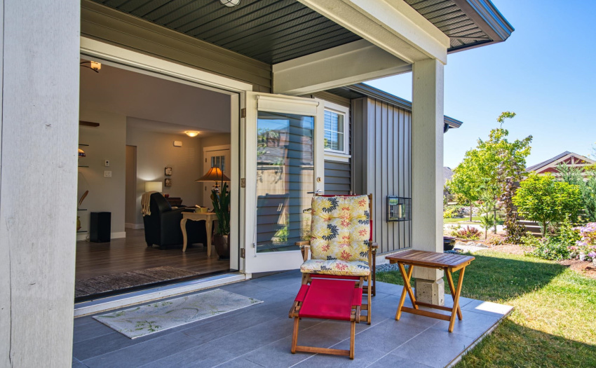 New tiled patio with french doors leading from house