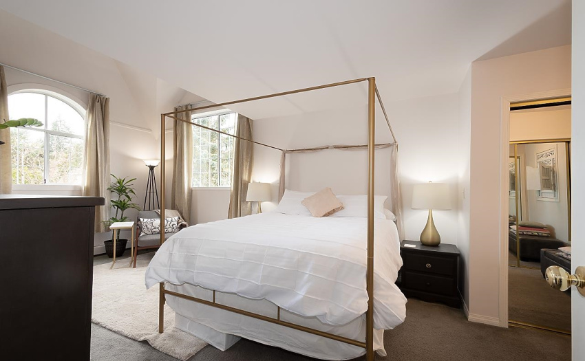 Spacious primary bedroom with vaulted ceilings and ensuite