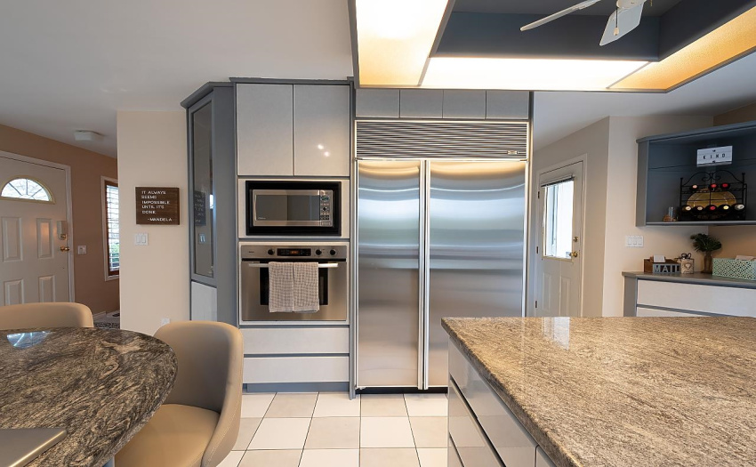 Kitchen is equipped with gas stove, stainless steel appliances, hot water tap & more!