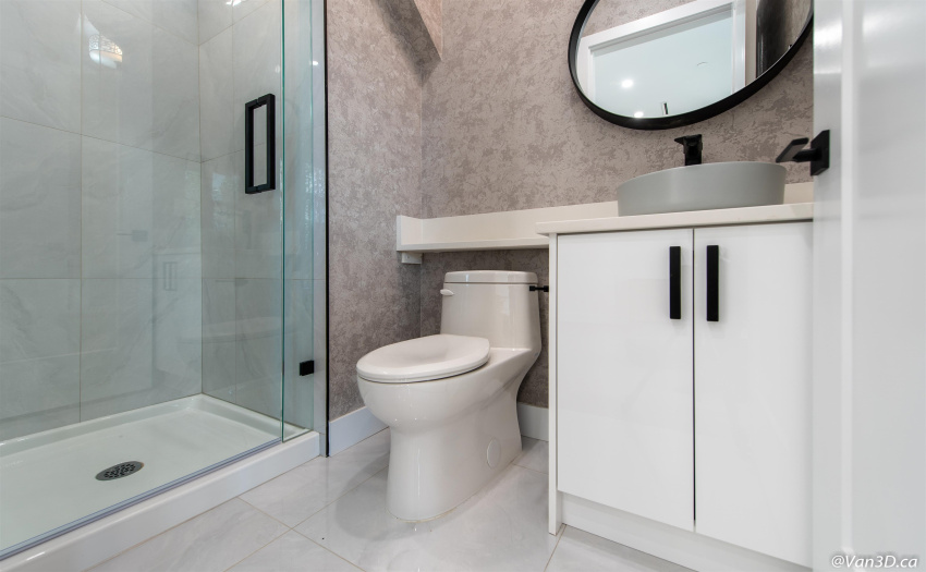 Full bathroom on main floor with high end finishings, stone countertops, and black hardware accents.