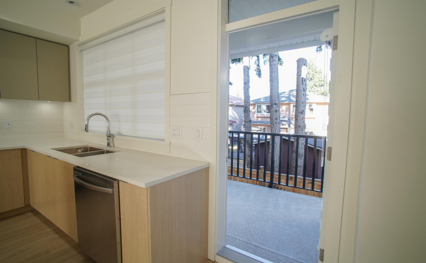 As seen after coming up the stairs, a spacious kitchen with one of the biggest patios in the complex.