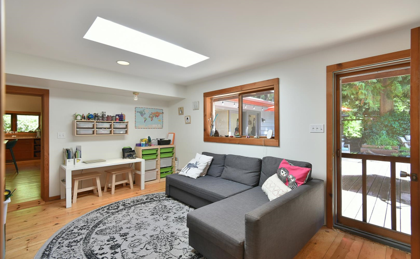 The living space off of the other two bedrooms, presently utilized as the 