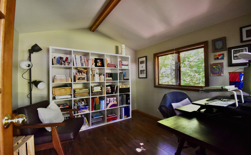 Plenty of space to keep a bookshelf, work desk, and a seat for clients or guests.