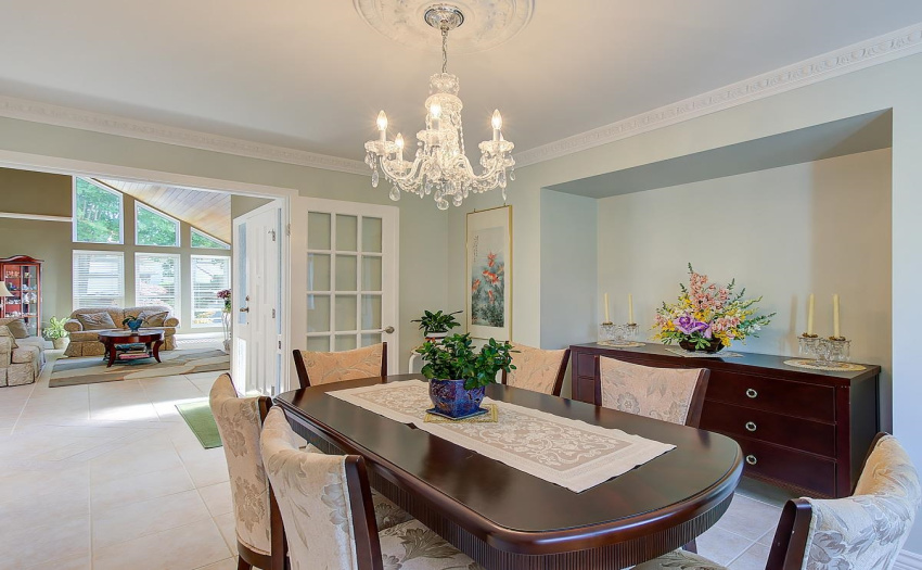 The large well planned dining room has an area for a hutch or side table as well crown mouldings, and separate doors for privacy. You could also fit a much larger dining table here.