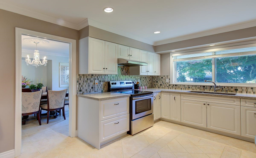 With Granite Countertops, High End Stainless Steel Appliances,  this bright kitchen has recessed lighting, quality cabinets with extra storage in the nook area. Wide open window to let the sunshine and fresh air in.