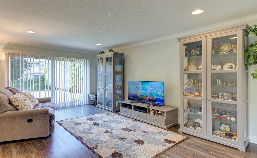 This is the good life!  This Family room says it all with French sliding doors, recessed lights, Crown Moulding, and Hardwood floors. Open the French Patio Doors, and let the fresh, fresh air in! Stroll out to the patio to hear the sound of birds singing.