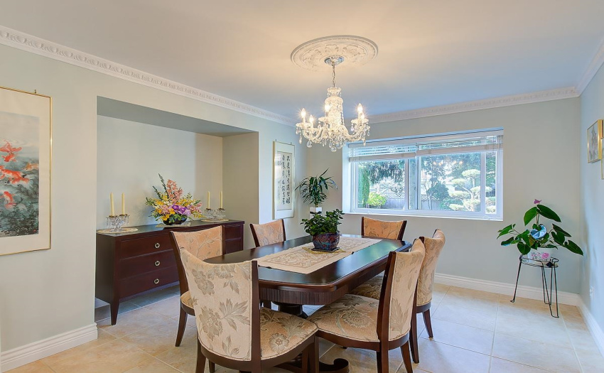 Tasteful, elegant dining room with marble tiles, crown moulding, new high quality blinds and an additional bonus area for a hutch.