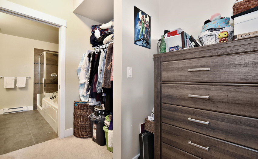 room for a dresser and space to hang clothes in the walk through closet