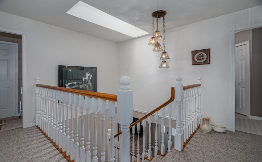 Large central hall with skylights add to the bright open feeling in this home.