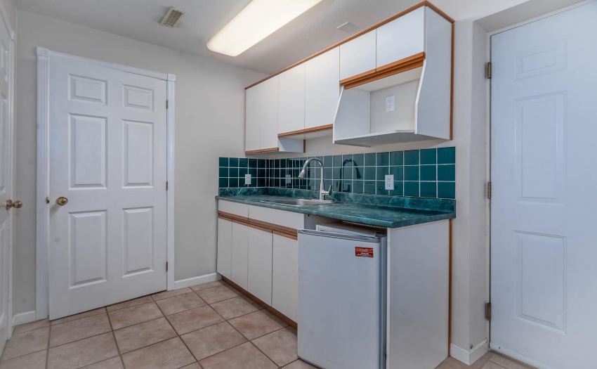 This mud room is right beside the garage entrance. It could easily be converted into a summer kitchen.