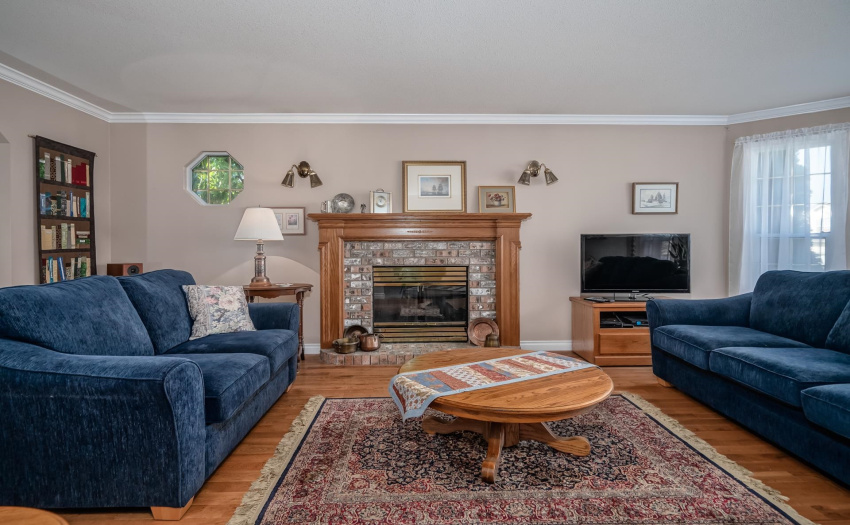 Hardwood floors grace the forma living and dining rooms. Living room boasts a beautiful brick fireplace and large bay windows. These features make this large room feel cozy and inviting.