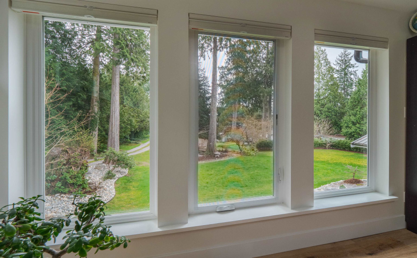 Large windows overlook the main gardens and views to front of the property.