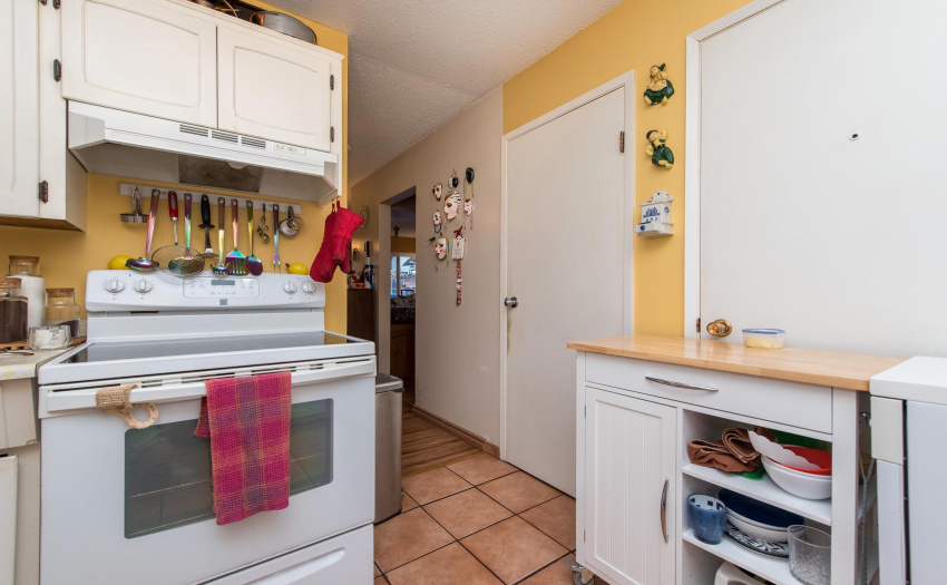 Kitchen with door to workshop & door to pantry cupboard