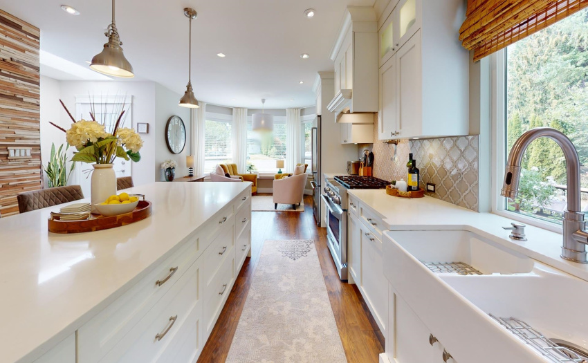 Tastefully Renovated kitchen with stone counters, upper end appliances, large double sink