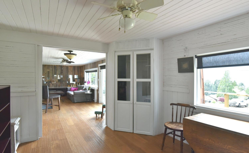 View back to main living room.  Cute corner cabin - a bright room with views